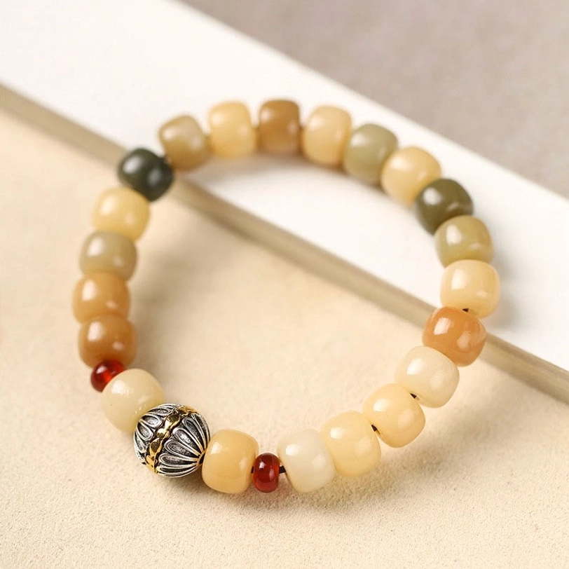 Bodhi seed enlightenment bracelet, handmade from natural materials with earth tone beads and decorative focal charm