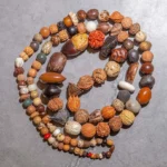 108 Bodhi seed mala beads bracelet flat lay, natural brown earthy tones coiled circular design for meditation and prayer