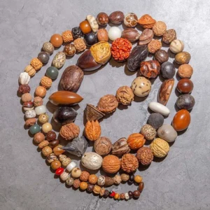 108 Bodhi seed mala beads bracelet flat lay, natural brown earthy tones coiled circular design for meditation and prayer
