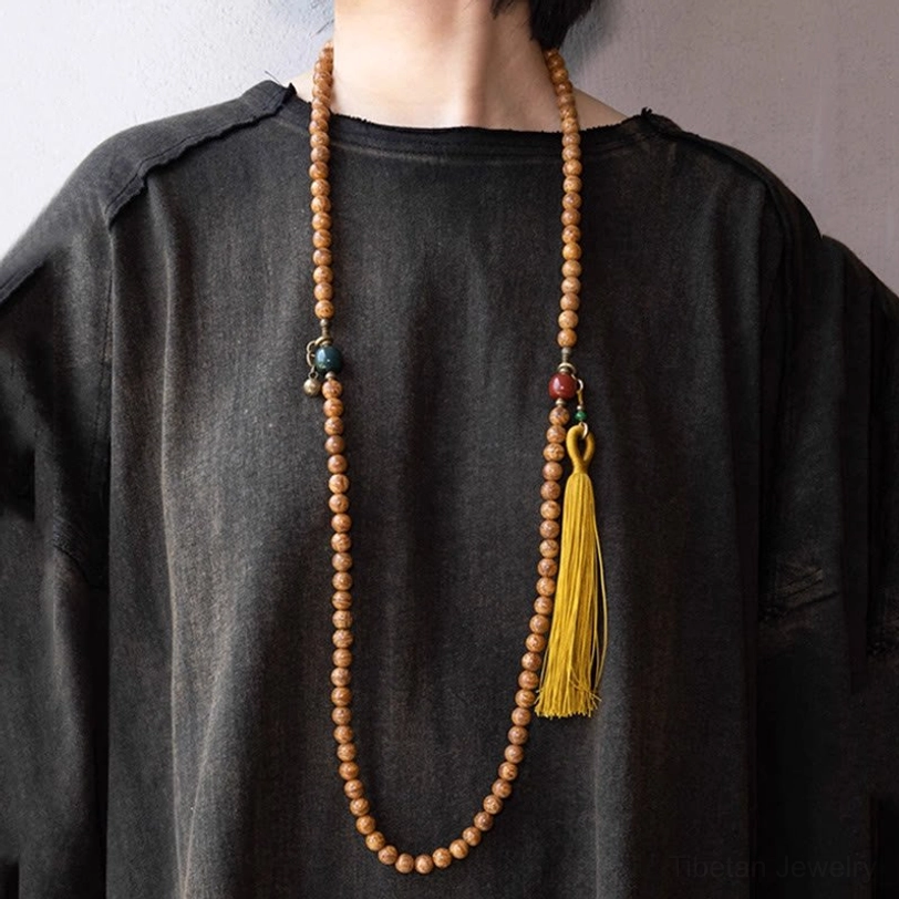 Long Tibetan bodhi seed prayer mala worn over black top showing full length necklace style