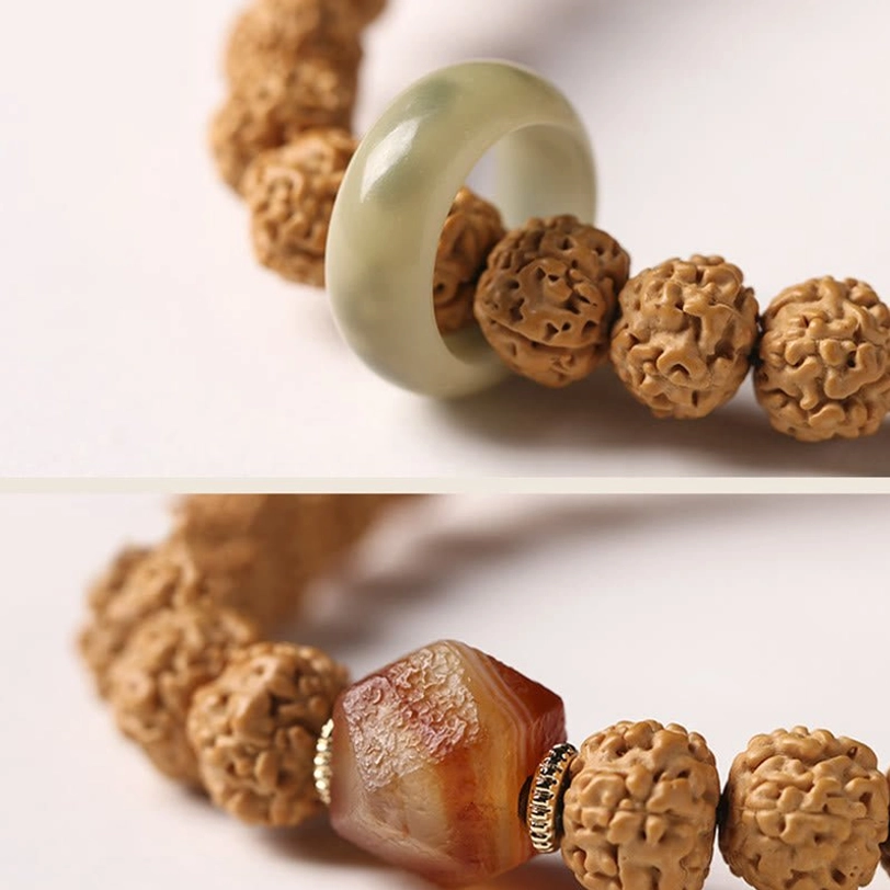 Coiled Bodhi seed mala with three-eye Dzi bead, sandalwood beads, and protective amulet charms