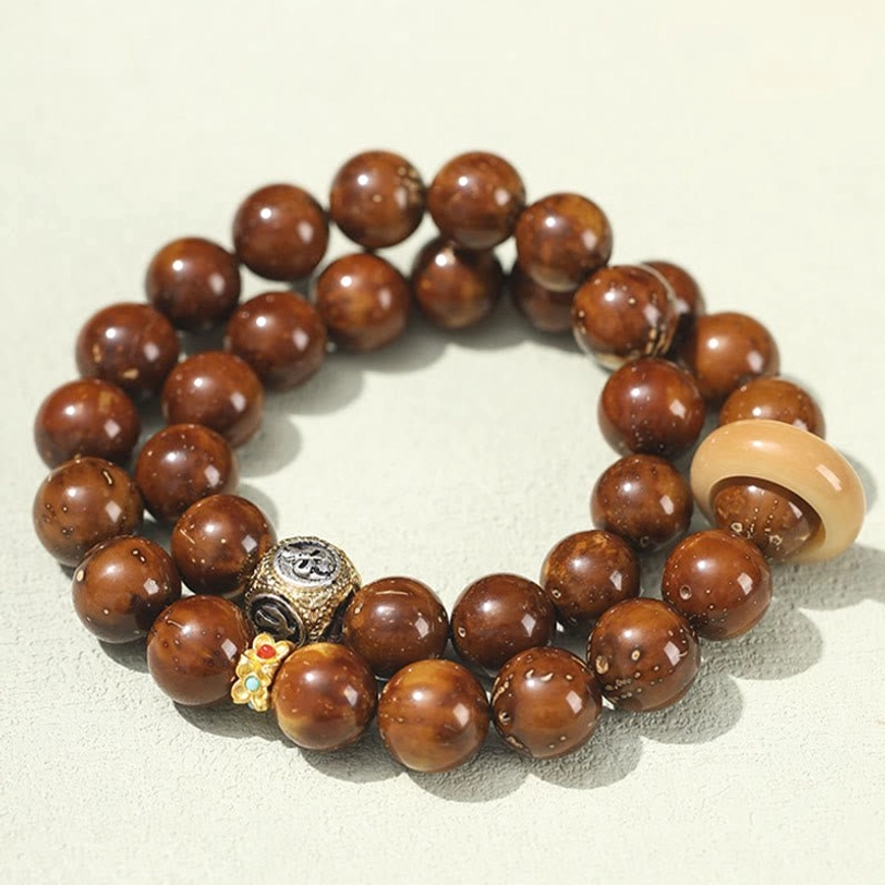 Dark brown natural Bodhi seed double wrap bracelet with decorative silver charm and bone spacer rings