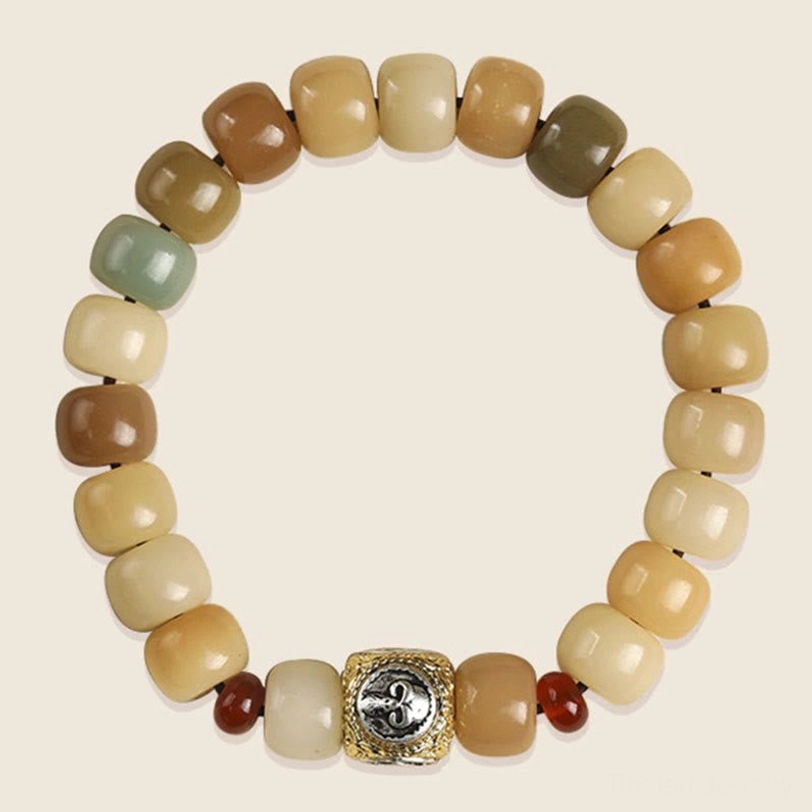 Handmade bodhi seed protection bracelet with branded metal charm, overhead product photography showcasing multicolor earth tone beads