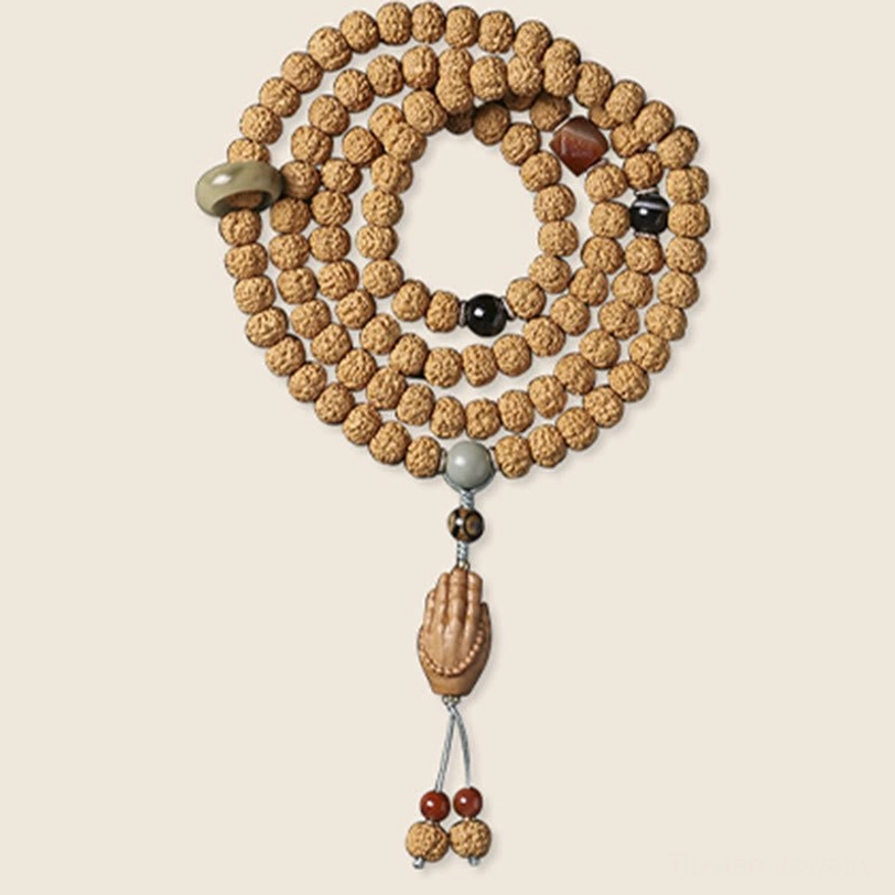 Close-up detail of Bodhi seed beads with three-eye Dzi bead showing natural texture and spiritual craftsmanship