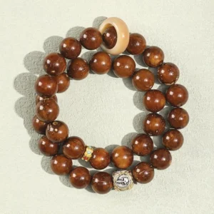 Tibetan double wrap Bodhi seed bracelet with bone spacer ring and minimal decoration on neutral background