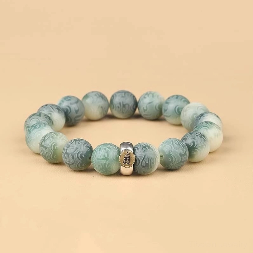 Tibetan Bodhi seed bracelet with Om Mani Padme Hum engraving and zodiac natal Buddha charm, flat lay top view