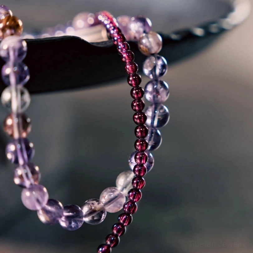 Macro detail of amethyst garnet bracelet beads showing crystal texture and metal hardware