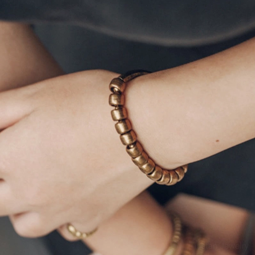 Premium brass abundance bracelet with natural copper patina, representing wealth attraction and metaphysical energy conduction