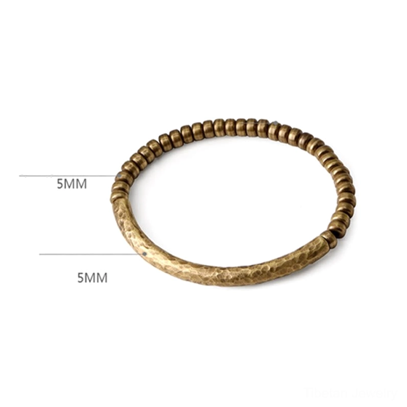 Tibetan brass beaded bracelet with 5mm bead size reference, overhead flat lay on white background for sizing clarity