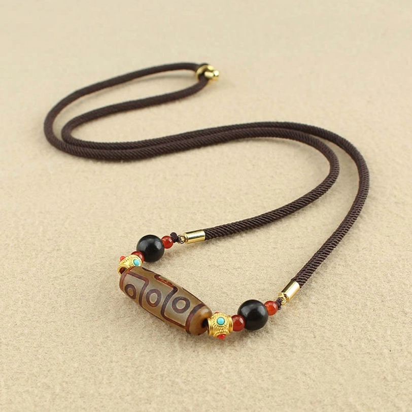 Brown nine-eye dzi bead Tibetan necklace with protective amulet design