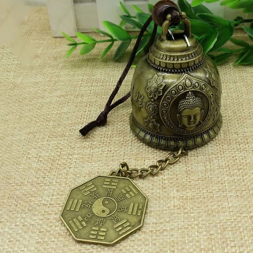 Buddha and Bagua embossed Tibetan wind chime featuring sacred geometry feng shui symbols on antique bronze