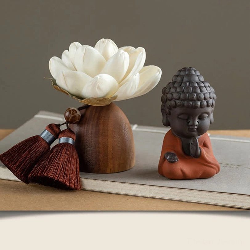 Dark clay Buddha figurine with lotus holder and essential oil aromatherapy desk decoration, top-down view