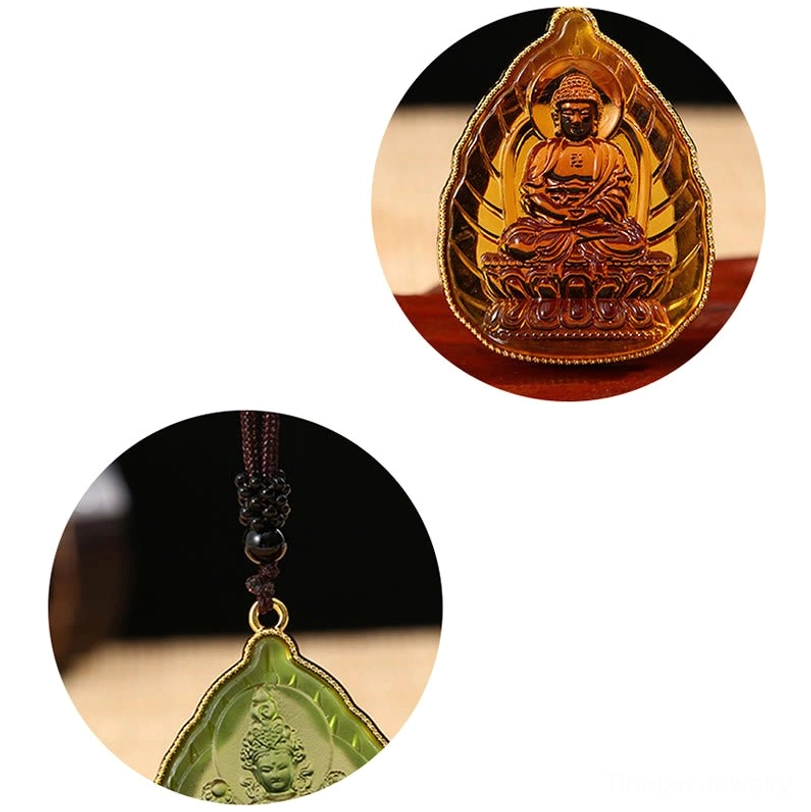 Close-up comparison of golden and green Buddha crystal pendants with detailed carving against white background