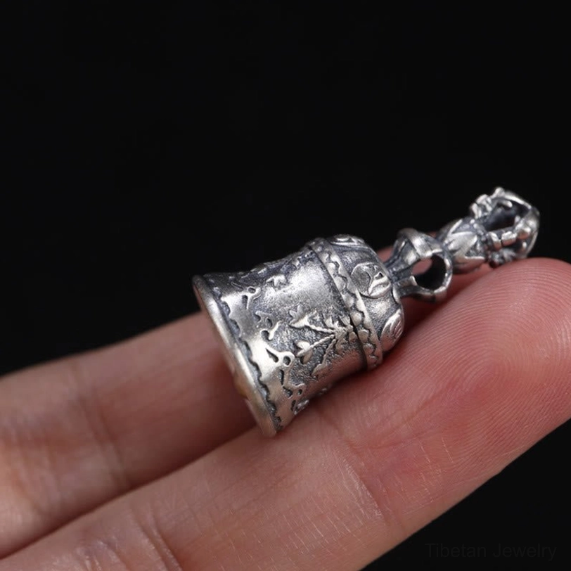 Buddhist dorje bell pendant with indestructible diamond symbolism and thunderbolt spiritual power representation
