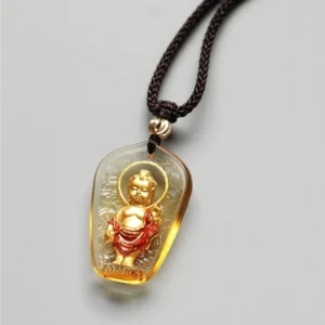 Mini Buddha Liuli crystal pendant necklace, small-sized amber translucent crystal with hand-painted Buddha design, close-up detail shot on light gray background