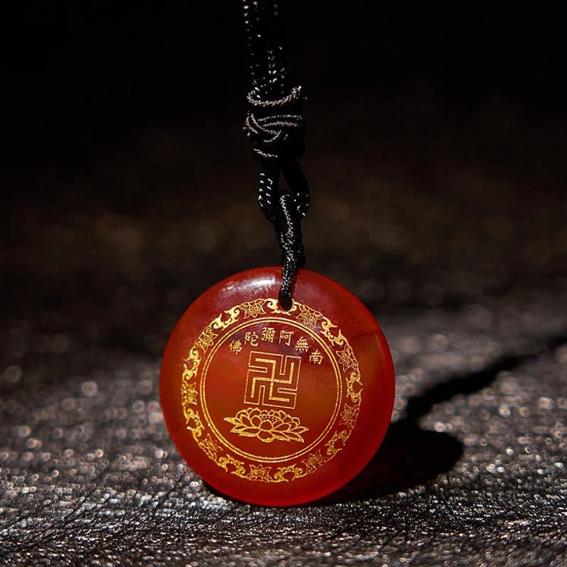 Buddhist pendant necklace product shot showing golden engravings and stone quality