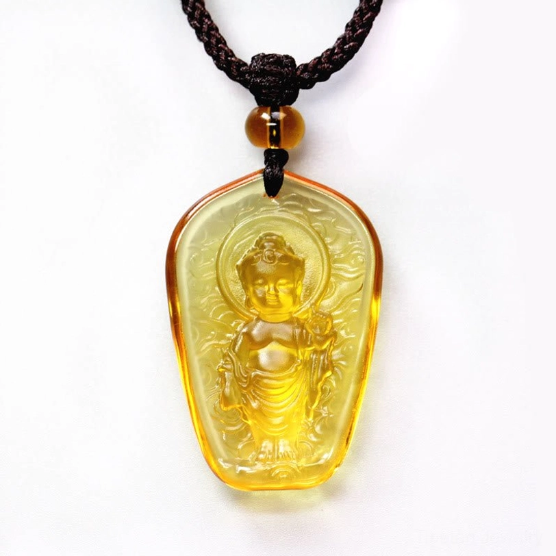 Standing Buddha Liuli crystal pendant necklace, solid amber yellow translucent stone with hand-carved standing Buddha figure and halo detail, front oblique view