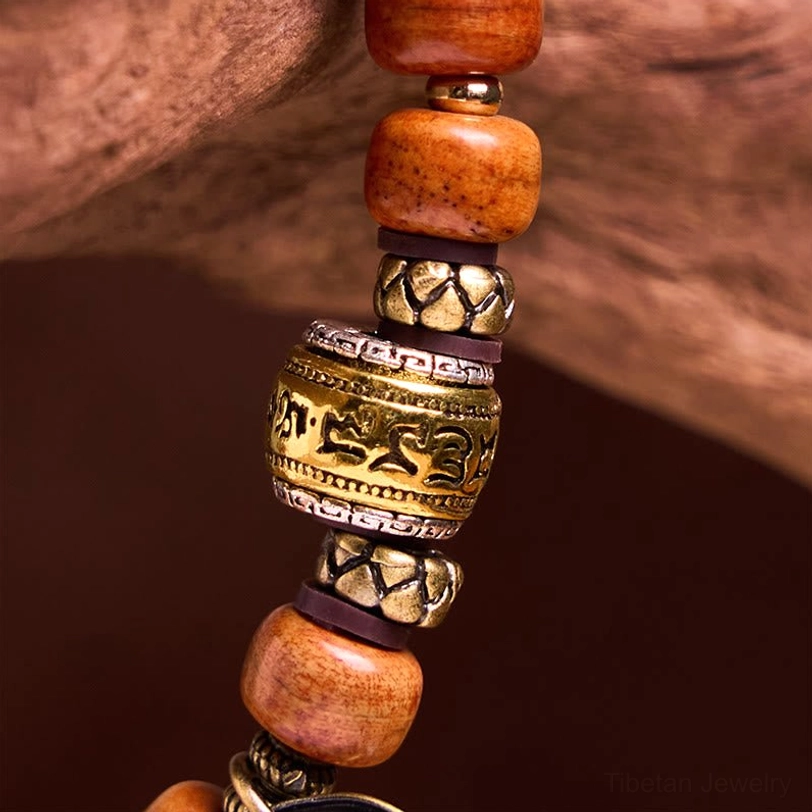 Macro close-up of camel bone barrel beads with Sanskrit metal spacer beads showing natural texture and craftsmanship details