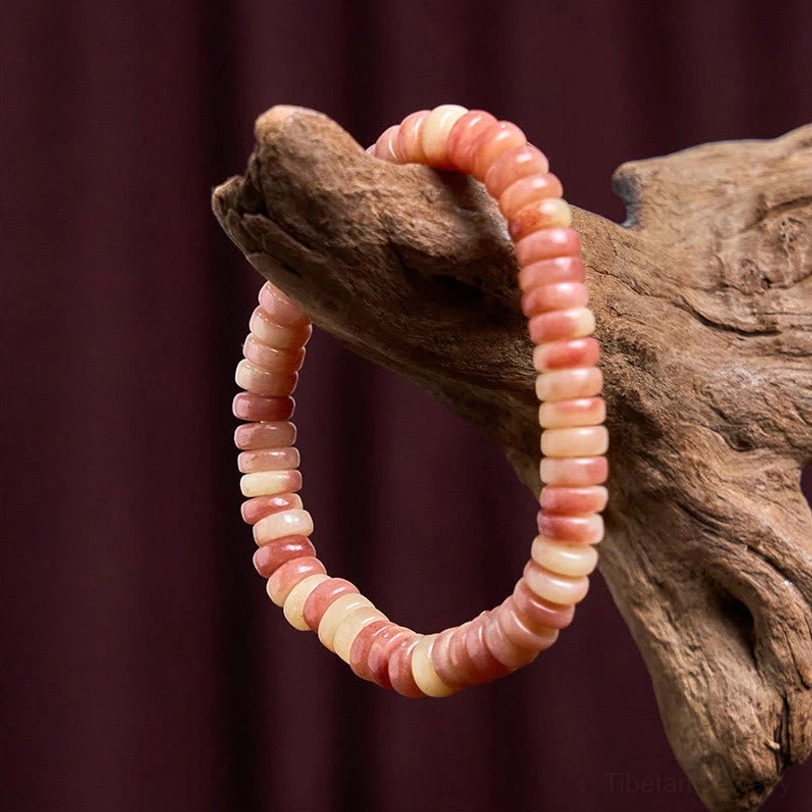 Camel bone spiritual protection bracelet draped over natural driftwood prop with gradient worn bone bead colors