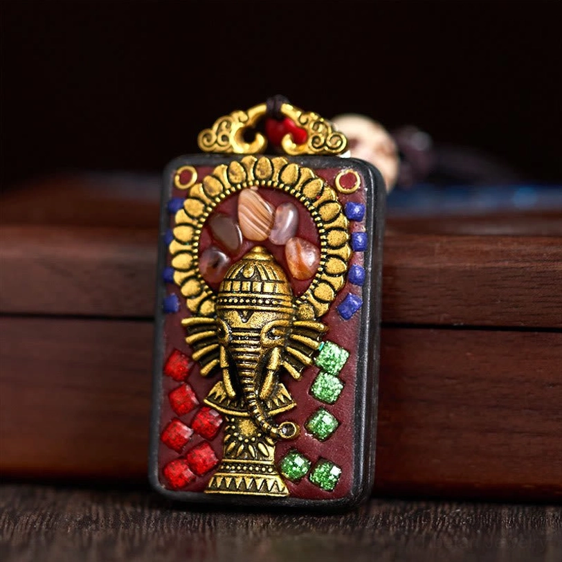 Carved ebony wood Ganesha pendant with warm spiritual energy aesthetic