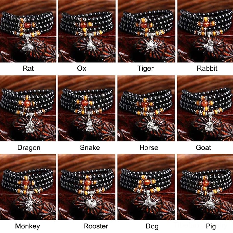 Complete 12 zodiac animal mala bracelet collection displayed on red fabric - rat, ox, tiger, rabbit, dragon, snake, horse, goat, monkey, rooster, dog, pig