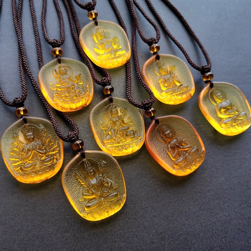 Complete collection of Chinese zodiac Natal Buddha Liuli crystal pendants displayed with woven cords showing all 12 protector bodhisattvas