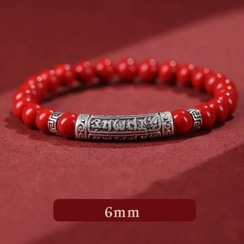 6mm cinnabar beads detail close-up showing polished deep red stone spheres with sterling silver engraved charm
