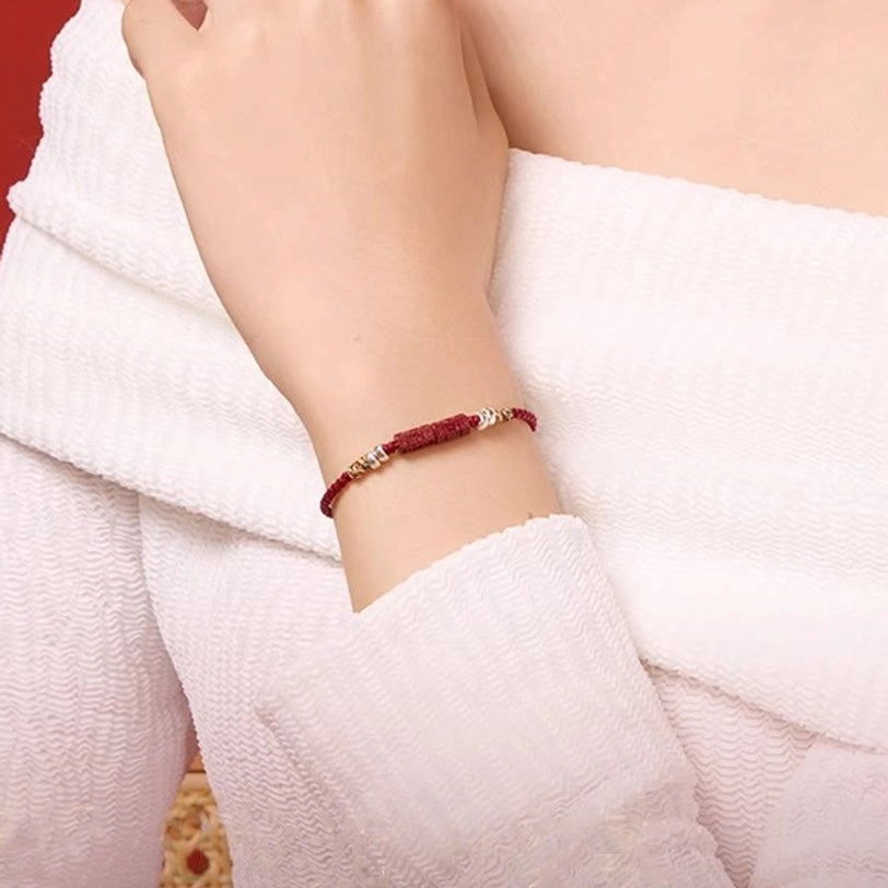 Red string cinnabar bracelet with sterling silver beads detailed product photography