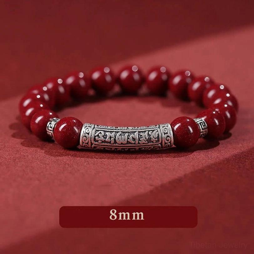 8mm cinnabar Six True Words bracelet side flat lay with size indicator showing larger polished red beads and detailed silver engraved tube