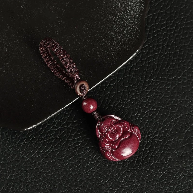 Cinnabar Buddha keychain charm with wooden ring and woven brown rope attachment
