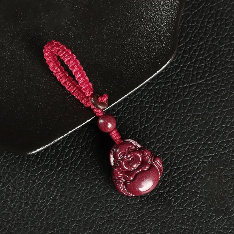 Red cinnabar Buddha keychain pendant with intricate Maitreya carving and woven knot detail