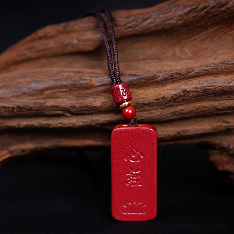 Cinnabar Heart Sutra Lotus pendant necklace back view showing reverse side carving on natural red stone