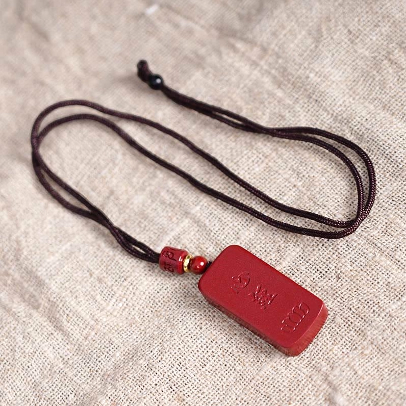 Cinnabar Lotus Heart Sutra pendant necklace full product shot showing cord attachment and pendant positioning