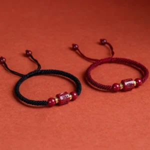 Tibetan cinnabar blessing bracelet comparison - two styles with black and red woven cords featuring carved prayer beads and adjustable ties