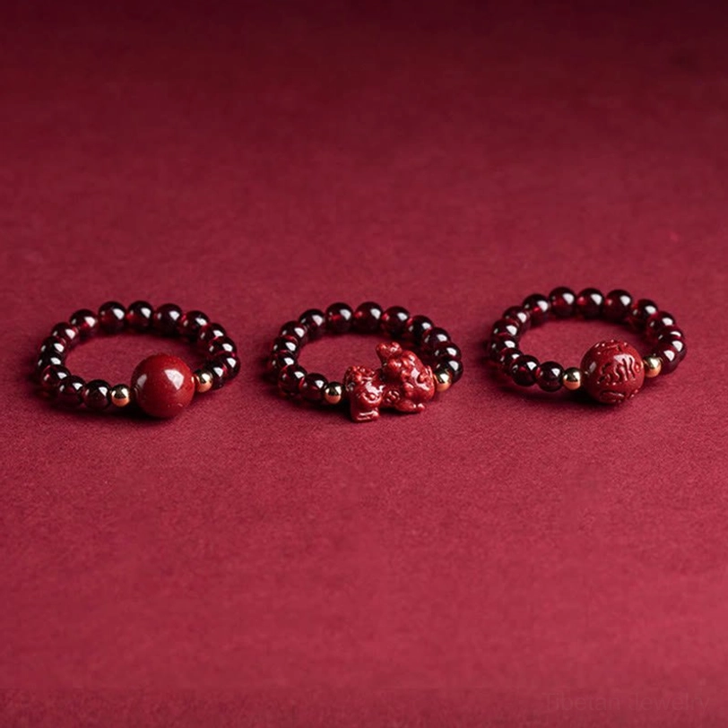 Three styles of cinnabar protection rings featuring PiXiu charm and round beads with precious metal accents on deep red background