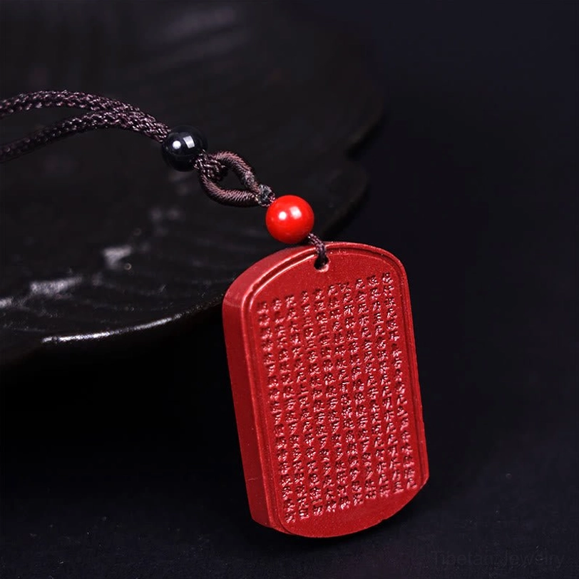 Cinnabar Heart Sutra pendant necklace front close-up showing complete sacred Sanskrit text engraving with red stone finish