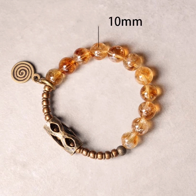 Citrine 10mm bead bracelet on light background with marked bead size and vintage spiral pendant