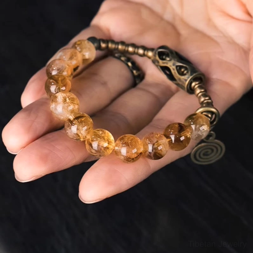 Citrine 10mm beaded bracelet with elastic string showing flexible design and durability