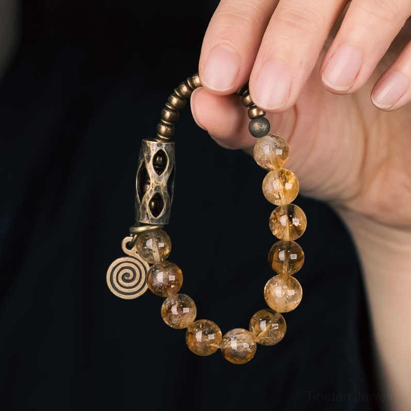 Citrine bead bracelet hand-worn demonstration displaying comfort fit and golden bead color