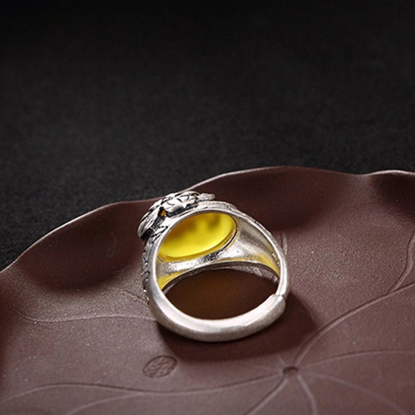 Rear bottom view of adjustable citrine lotus ring on lotus-leaf tray displaying open adjustable ring base and back of gem setting