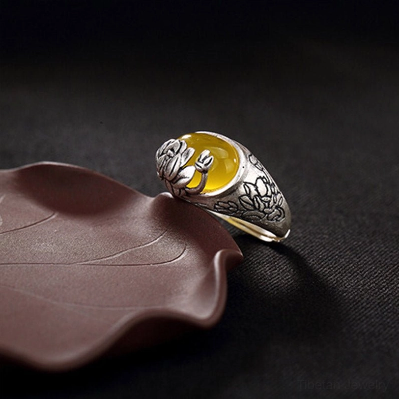 Right side view of vintage silver citrine lotus ring with matte copper band and embossed lotus bud detail on gem setting