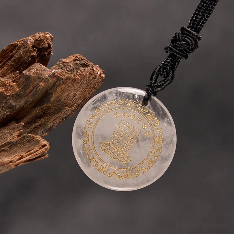 Clear quartz Buddhist pendant three-quarter view with wooden decorative element