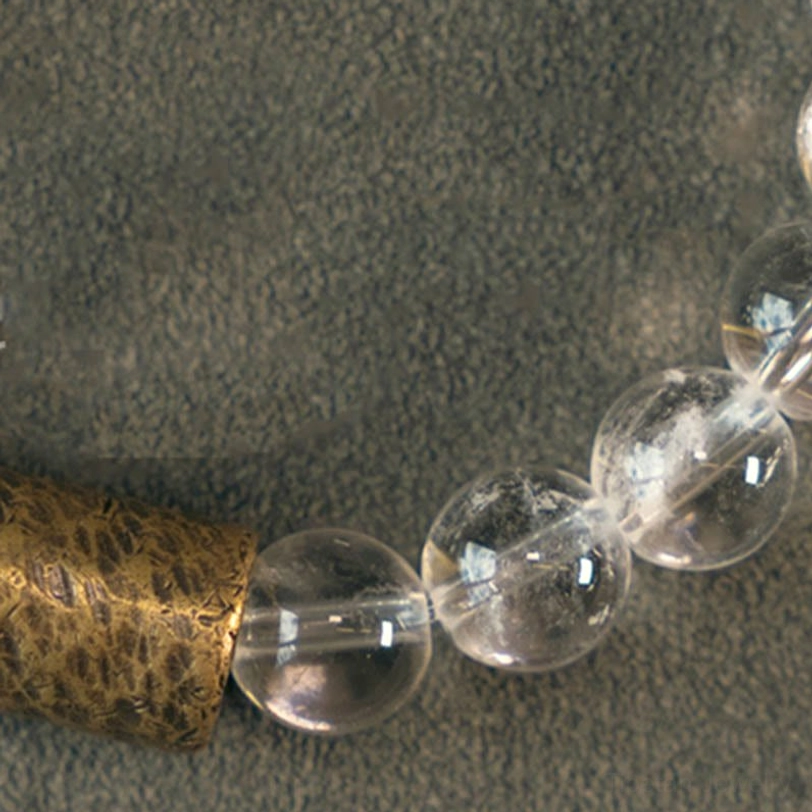 Macro close-up of crystal bracelet beads showing internal clarity and natural formations of clear quartz