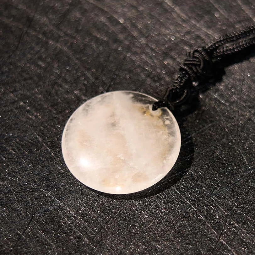 Clear crystal Buddhist pendant with natural inclusions and black braided cord