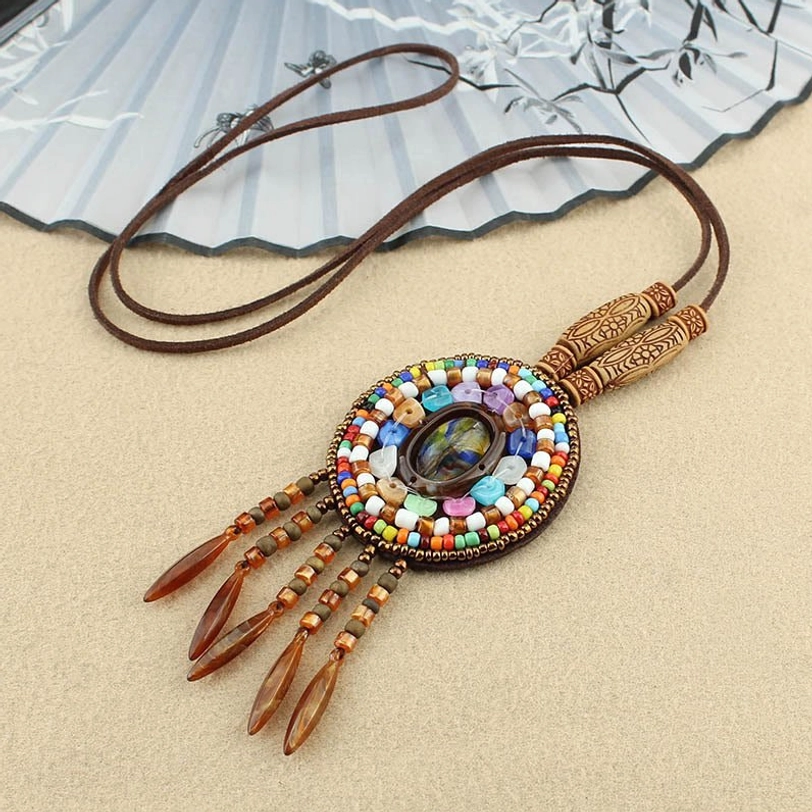 Single multicolor beaded mandala pendant necklace with brown leather tassel and adjustable wax cord, 3/4 view