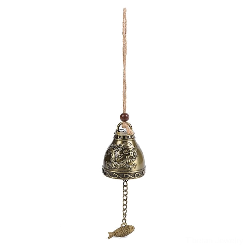 Compact Tibetan feng shui wind chime hanging vertically with embossed patterns and fish charm on white background