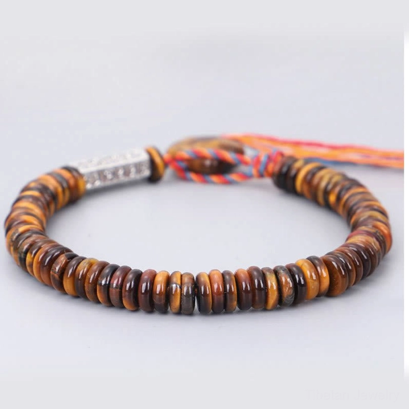 Complete tibetan tiger eye om mani protection bracelet flat lay showing full circle of disc beads and silver charm