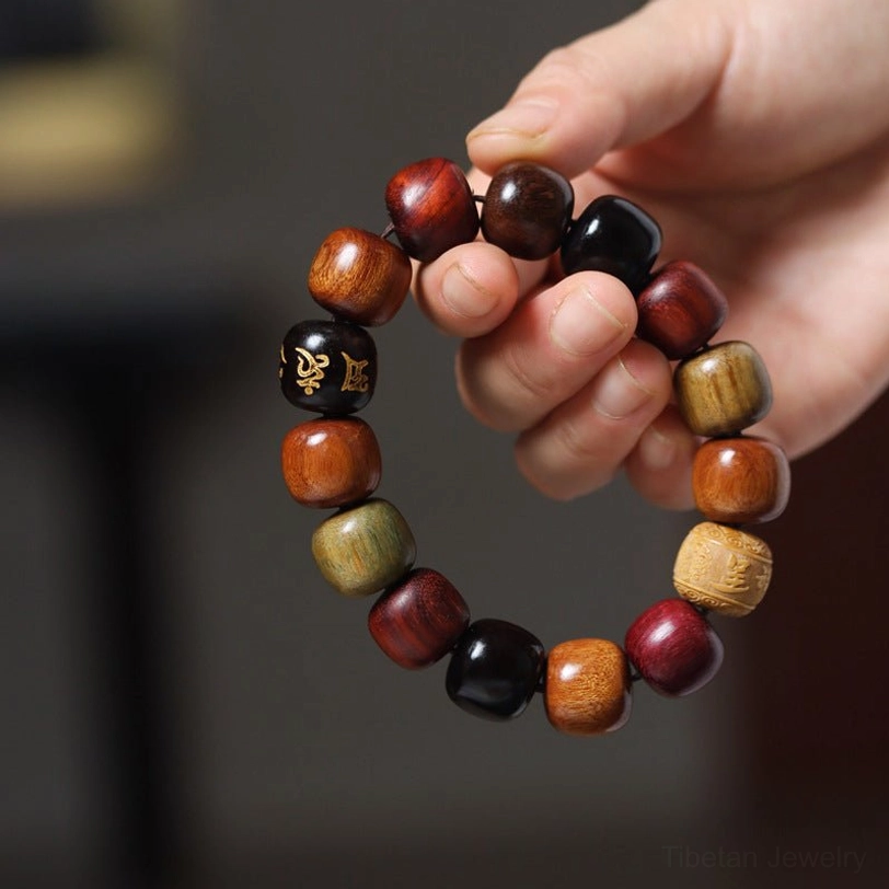 Full strand of Om Mani Padme Hum wooden mala bracelet with barrel-shaped mixed wood beads and engraved mantra bead