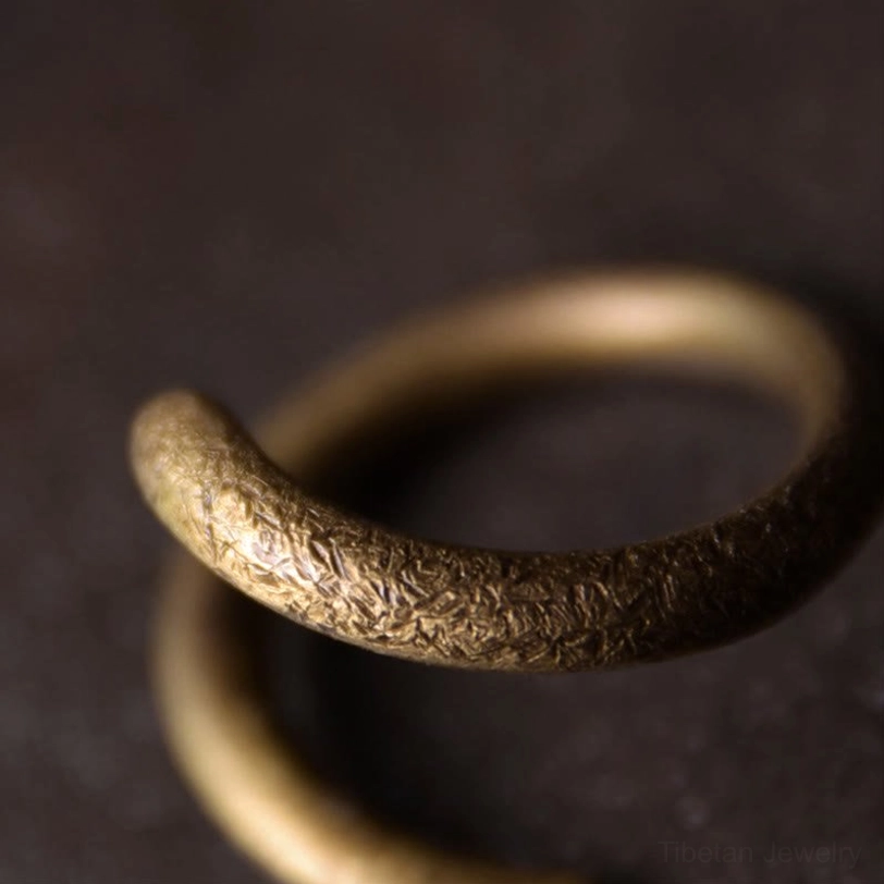 Adjustable copper ring extreme close-up showing mottled vintage surface and curved metal band thickness