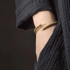 Antique bronze copper beaded cuff bracelet worn on wrist close-up view